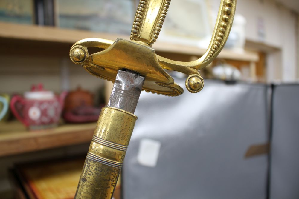 A cut steel dress sword by Ede & Ravenscroft of London and two brass hilted dress swords
